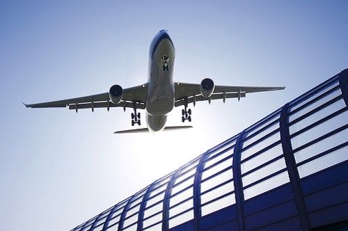 Image of an Airplane flying over a bridge